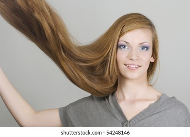 Young Woman With Hair Flying Over Grey