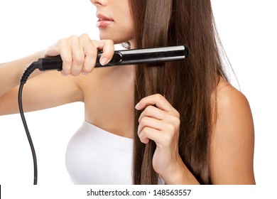 Young Woman With A Hair Straightener, White Background