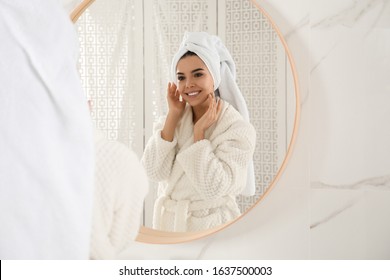 Young Woman With Hair Wrapped In Towel Near Mirror Indoors