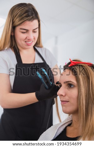Young woman hairdresser enjoying her work.