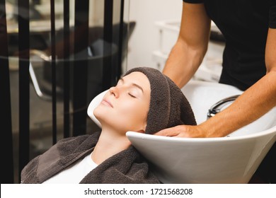 Young Woman In Hairdresser Salon During Hair Wash After Haircut