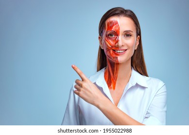 Young woman with half of face with muscles structure under skin pointing to looking left on copy space.. Model for medical training on a light background. Close up video of face human anantomy.