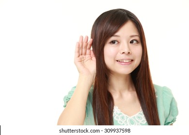 Young Woman With Hand Behind Ear Listening Closely?