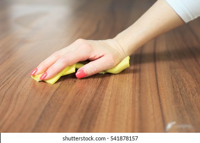 Young Woman Hand Cleaning Modern Wood Table By Dust Cloth (color Toned Image)