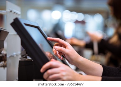 Young woman hand doing process payment on a touchscreen cash register, finance concept (color toned image) - Shutterstock ID 786614497