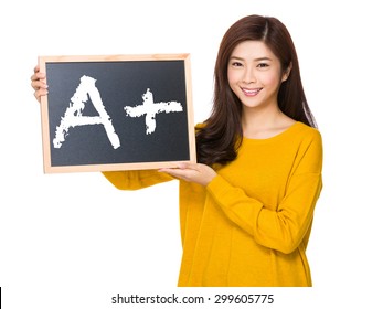 Young woman hand hold with the blackboard showing A plus mark