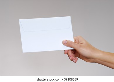 Young Woman Hand Holding An Envelope Isolated On A White Background.