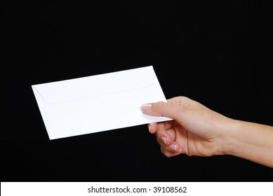 Young Woman Hand Holding An Envelope Isolated On A Black Background.