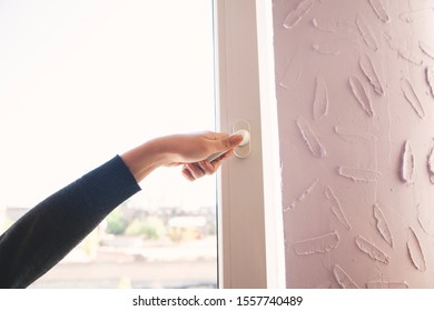 Young Woman Hand Opening The Window Door