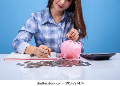 Young woman hand putting coin in piggy bank for saving money wealth.