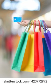 Young Woman Hand With Shopping Bags And Credit Card.