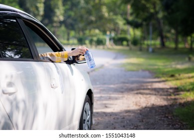 Young Woman Is Hand Throwing Plastic Bottle On The Road ,Concept Of Environmental Stewardship, Global Warming 