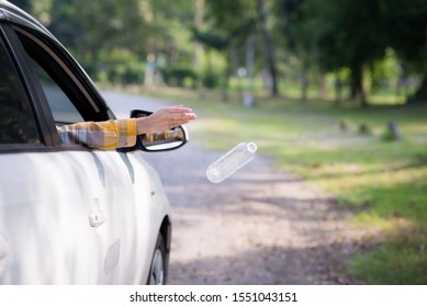 Young Woman Is Hand Throwing Plastic Bottle On The Road ,Concept Of Environmental Stewardship, Global Warming 