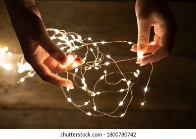 Young woman hands holding fairy lights.  - Powered by Shutterstock