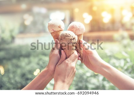 Young woman hands holding ice cream cones on summer