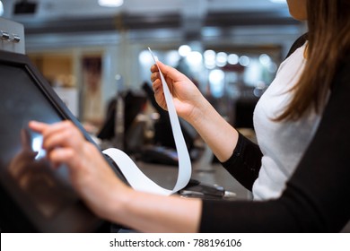 Young woman hands scaning / entering discount / sale on a receipt, touchscreen cash register, market / shop - Shutterstock ID 788196106