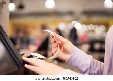 Young woman hands waiting for a prints of invoice for a customer at huge shopping center