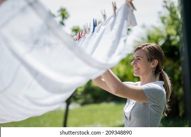 Young woman hanging up laundry