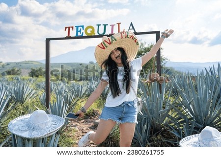 The young woman is happy in the agave field in the town of Tequila Jalisco Mexico.