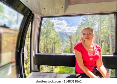 Young Woman Happy Girl Riding Free Cable Car Gondola By Trees Forest In San Juan Mountains In Telluride, Colorado Summer