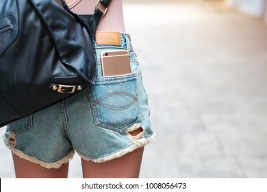 Young Woman Has Smart Phone In Pocket Jean 