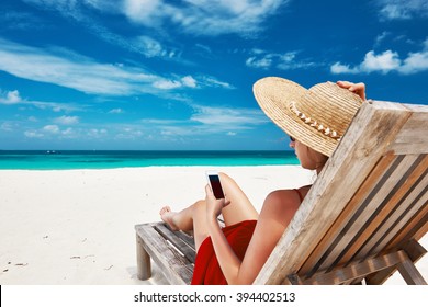 Young Woman In Hat With Mobile Phone At The Beach