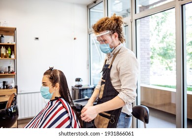 Young Woman Have Hair Cutting At Hair Stylist During Pandemic Isolation, They Both Wear Protective Equipment. Hair Dresser Working With A Face Mask During Coronavirus Quarantine