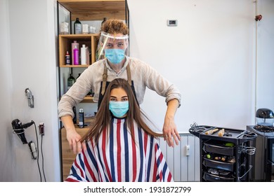 Young Woman Have Hair Cutting At Hair Stylist During Pandemic Isolation, They Both Wear Protective Equipment. Hair Dresser Working With A Face Mask During Coronavirus Quarantine