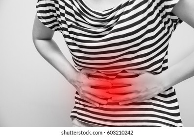 Young Woman Having Abdominal Pain, Upset Stomach Or Menstrual Cramps