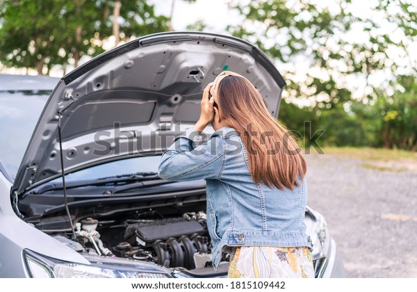 Young woman was having a bad car breakdown and\
felt frustrated while\
traveling