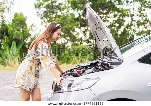 Young woman was having a bad car breakdown and\
felt frustrated while\
traveling
