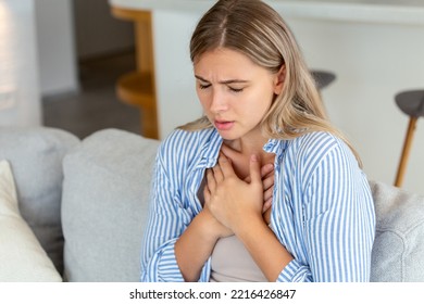 Young woman having chestpain,Acute pain, possible heart attack.Effect of stress and unhealthy lifestyle concept.