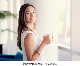 A Young Woman Having Coffee In Office