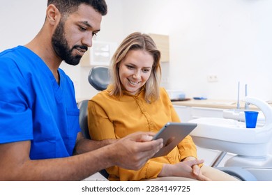 Young woman having consultation with multiracial dentist. - Powered by Shutterstock