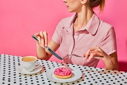Young Woman Having Delicious Breakfast With Donut And Coffee Over Pink Background. Yummy. Vintage, Retro Style Interior. Food Pop Art Photography. Complementary Colors. Copy Space For Ad, Text