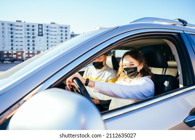 Young Woman Having Driving Lesson With Instructor During Covid 19.