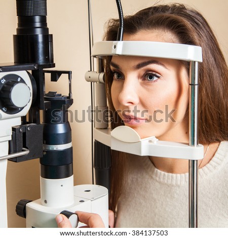 Young woman is having eye exam performed by eye doctor. Ophthalmologist. medical, health, ophthalmology concept