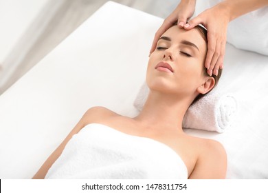 Young Woman Having Facial Massage In Beauty Salon