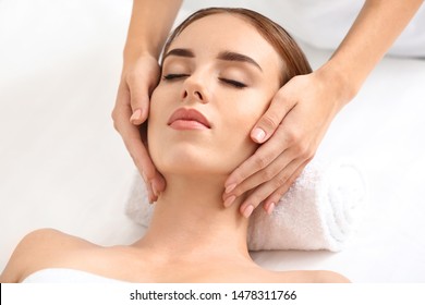 Young Woman Having Facial Massage In Beauty Salon