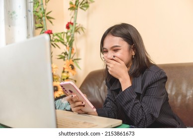 A young woman having fun reading a web novel. Laughing at the jokes she read. Getting giddy as she went to the exciting part.