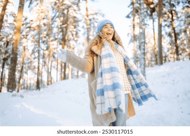 Young woman having fun, walking in a winter snowy park. People, season and Christmas concept. - Powered by Shutterstock