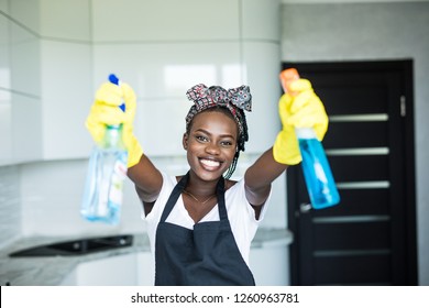 Young woman is having fun while doing cleaning at home. - Powered by Shutterstock