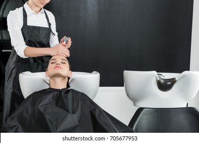 young woman having hair wash in beauty salon