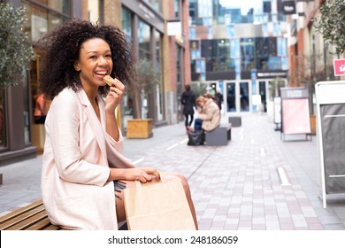 Young Woman Having A Healthy Snack In The Street