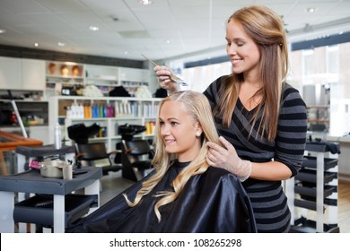 Young woman having her hair dyed by beautician at parlor - Powered by Shutterstock