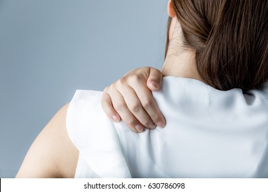 young woman having horribly stiff shoulders - Shutterstock ID 630786098