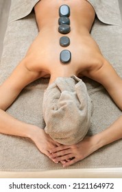 Young Woman Having Hot Stone Massage In A Beauty Centre, Top View