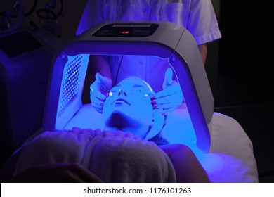 Young Woman Having LED Light Facial Treatment In Beauty Salon