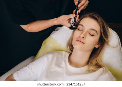 Young Woman Having Meeting With Plastic Surgeon