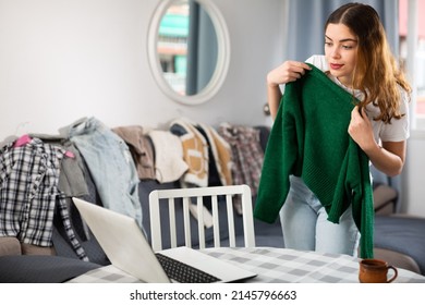 Young Woman Having Online Consultation With Personal Fashion Stylist About Her Wardrobe